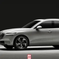 Biały Genesis GV70 na ładowarce. Elegancki SUV z charakterystycznym grillem i światłami LED.