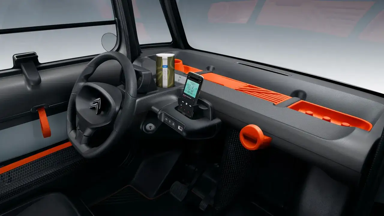 Wnętrze Citroen Ami z pomarańczowymi akcentami. Sprawdź atrakcyjną citroen ami cena i wyposażenie.